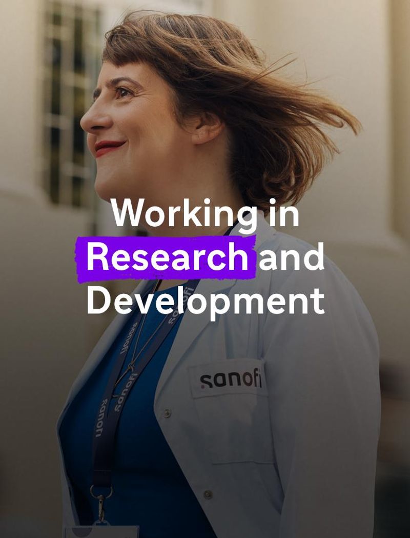 A smiling woman wearing a white Sanofi lab coat and company badge smiles while walking forward outside of a building. Several people are running alongside her in the background, they are blurred in motion. Overlay text reads: "Working in Research and Development."