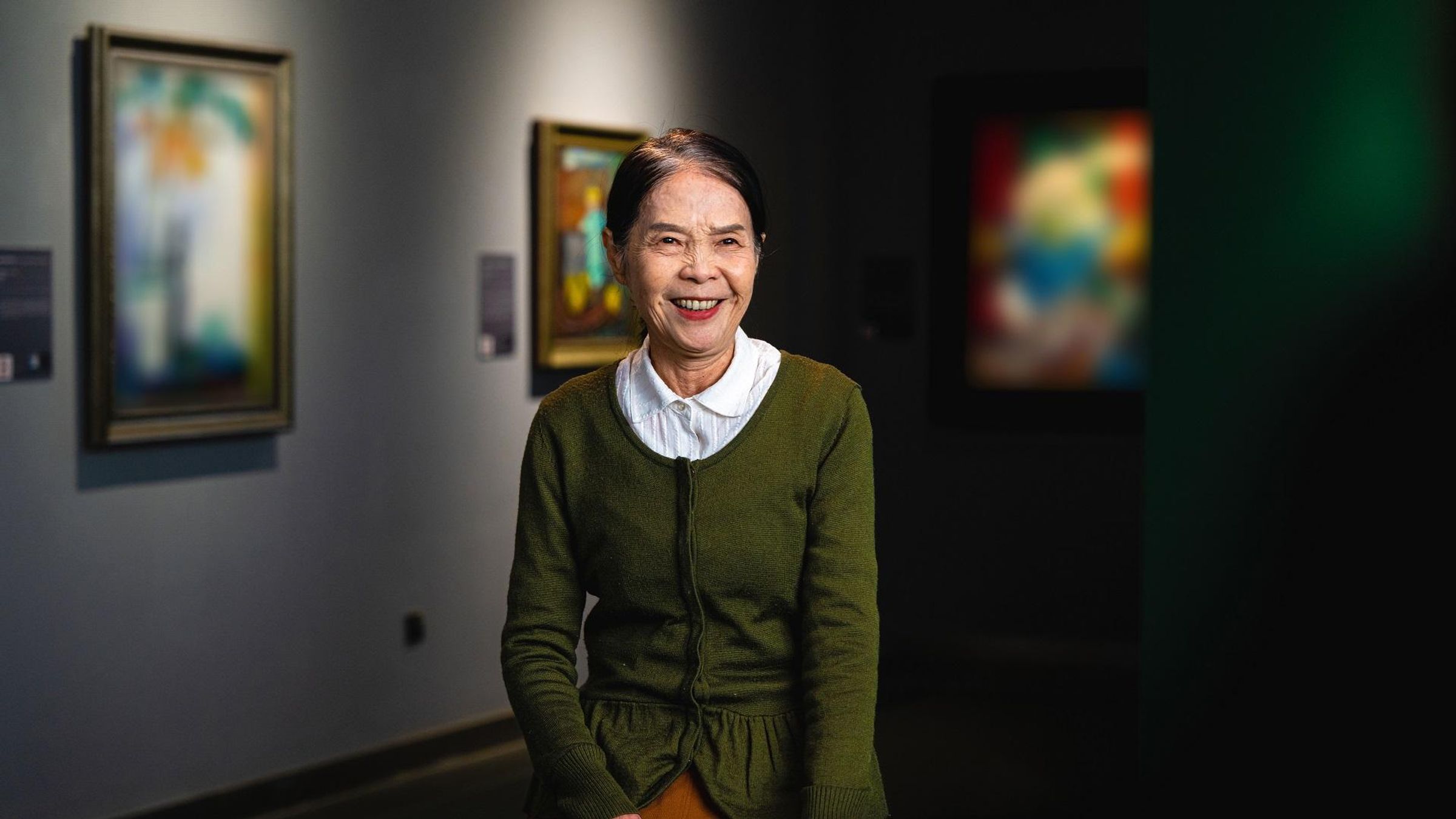 Chen Shaoqin working as a tour guide in an art gallery in Beijing, China