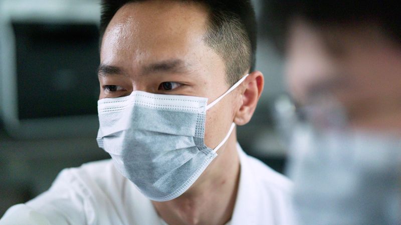 Young man on park bench with subtitle from video: 'Watching my grandmother fade away from Alzheimer's