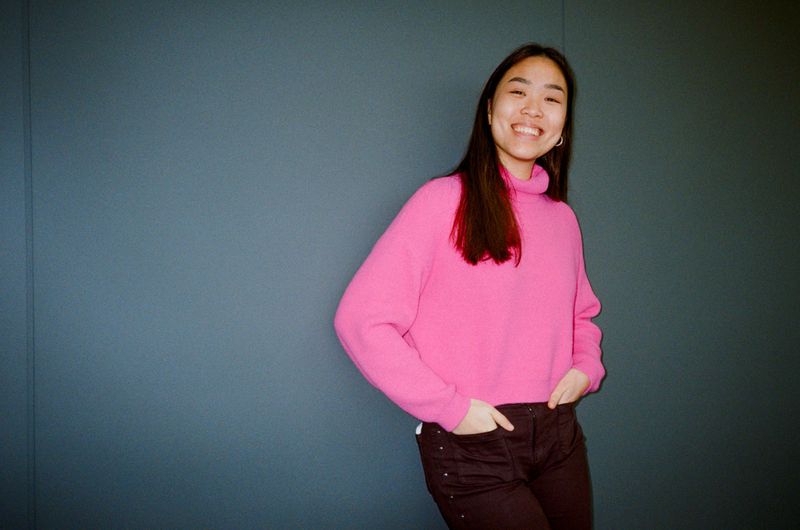 Four-photo family collage with subtitle from video: 'and my parents adopted me when I was little'